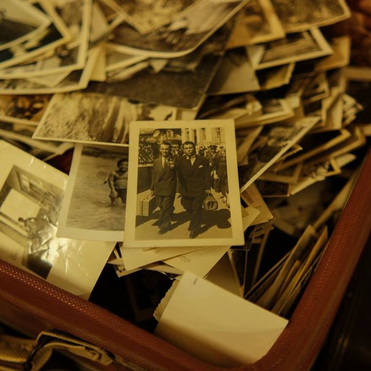 A case of loose old photographs waiting to be scanned