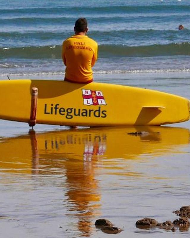 A modern photograph of a child on a beach on a bright day